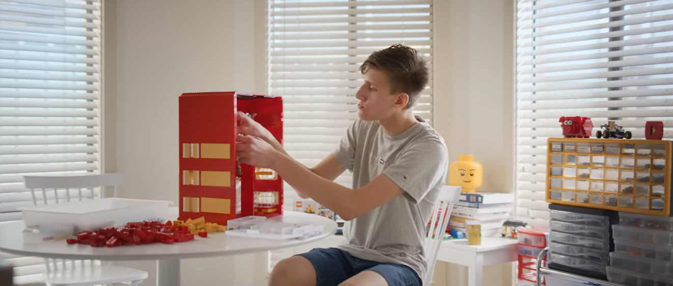 Creator building a LEGO machine in the series